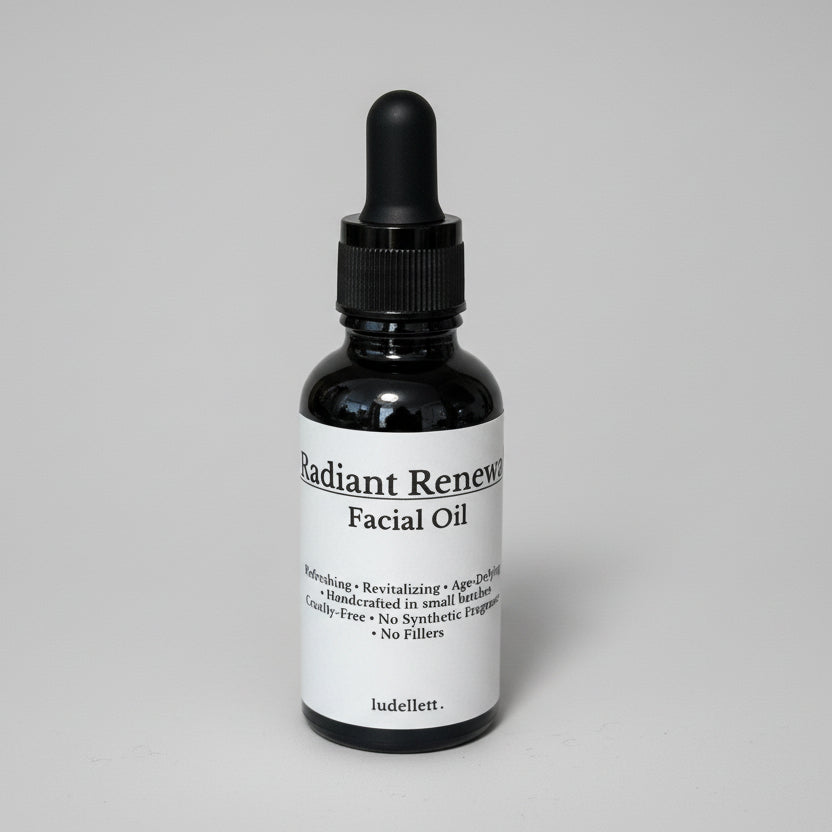 Facial oil bottle with dropper on a dark surface